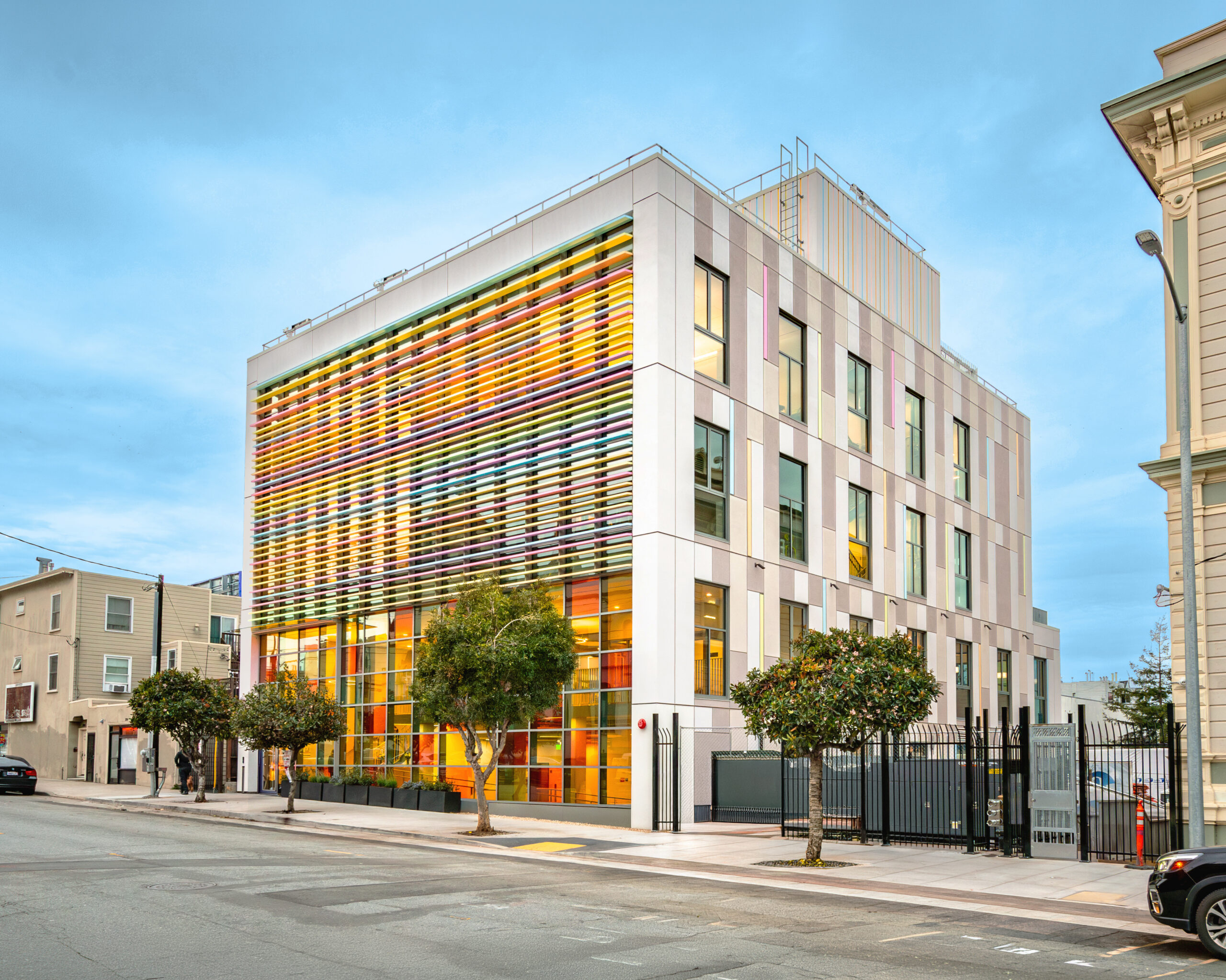 The Mission campus on its street corner, the facade striped with bands of colored glass