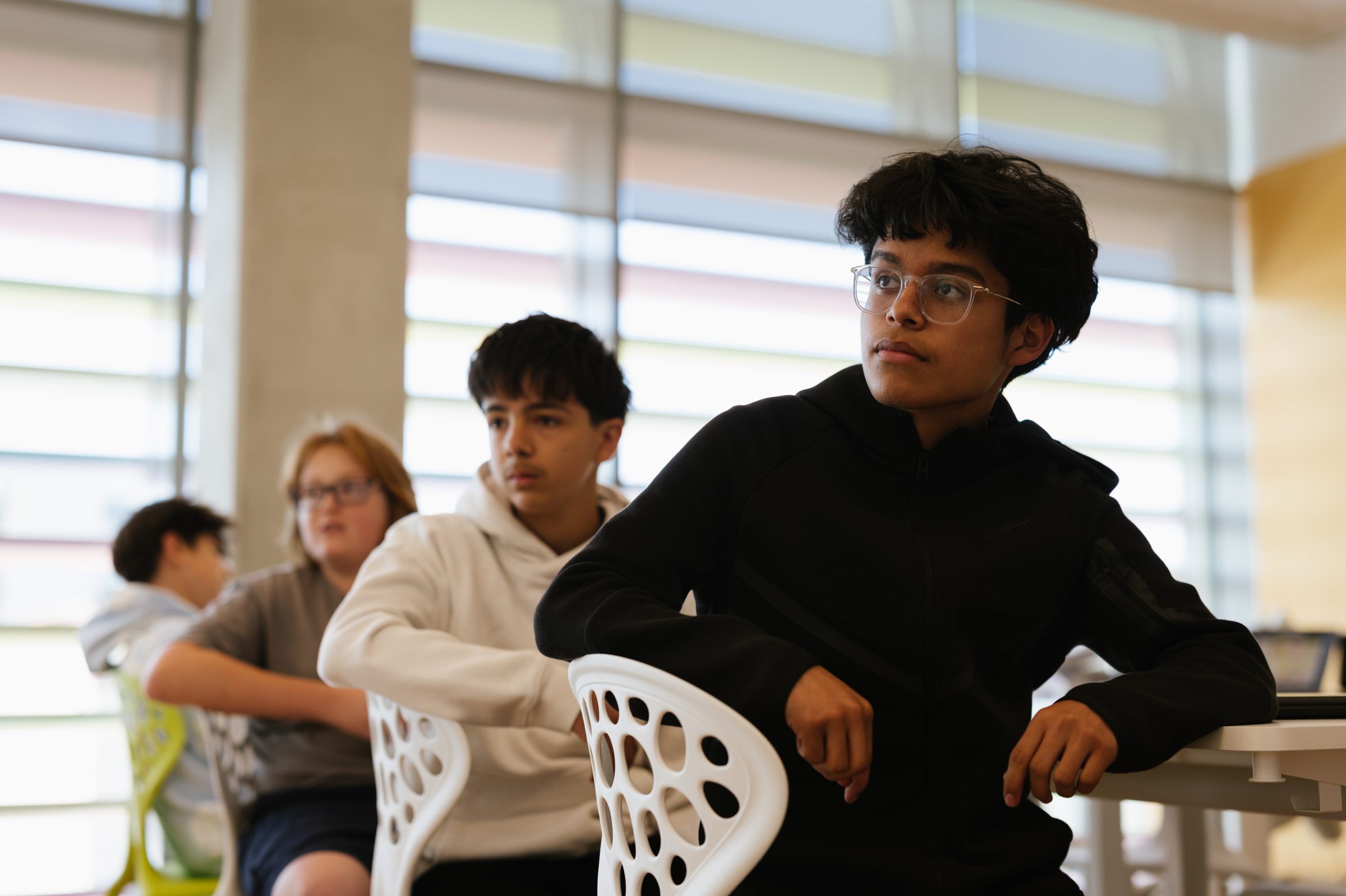 Middle school students sitting together at a classroom table