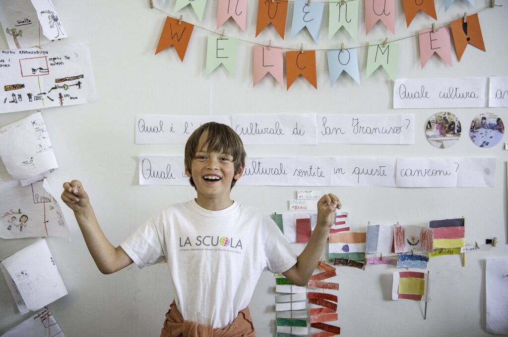 A student presenting Italian grammar work at the whiteboard