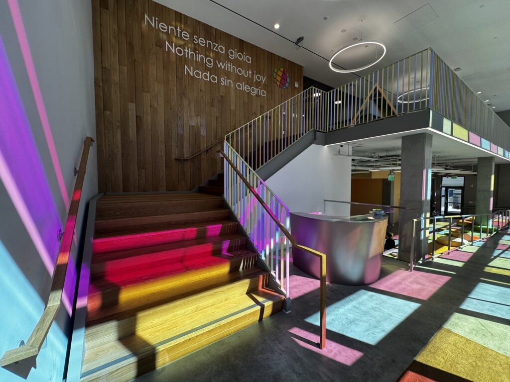 Coloured light from the glass panes falling across the entrance stair
