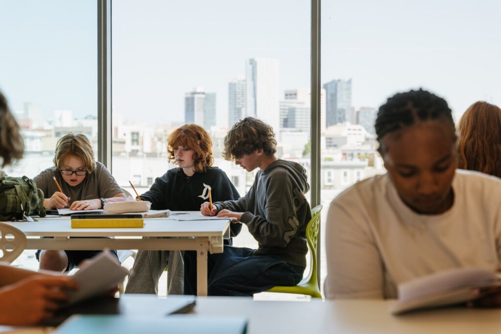Students studying at a window table above the city