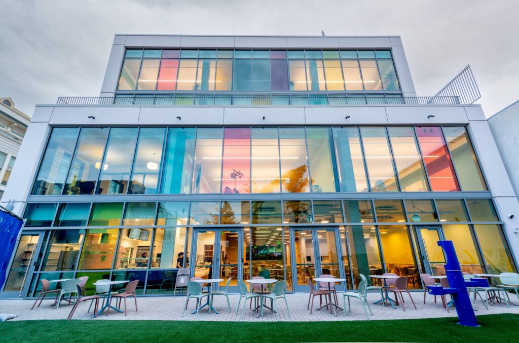 The Mission campus building lit up at dusk