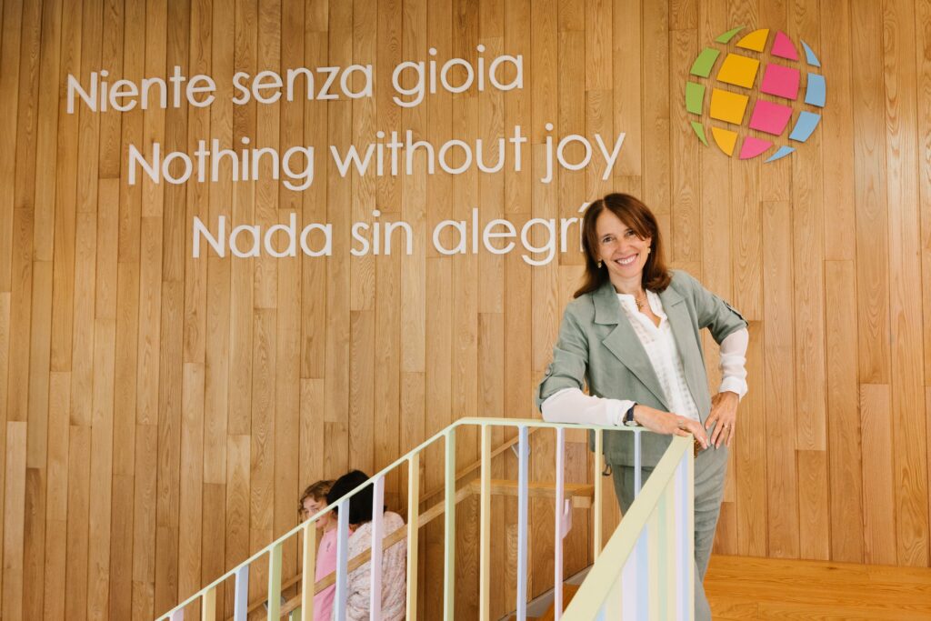 The Head of School on the stair beneath the school's motto