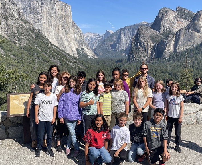 Students and teachers on a field trip in front of Yosemite Valley